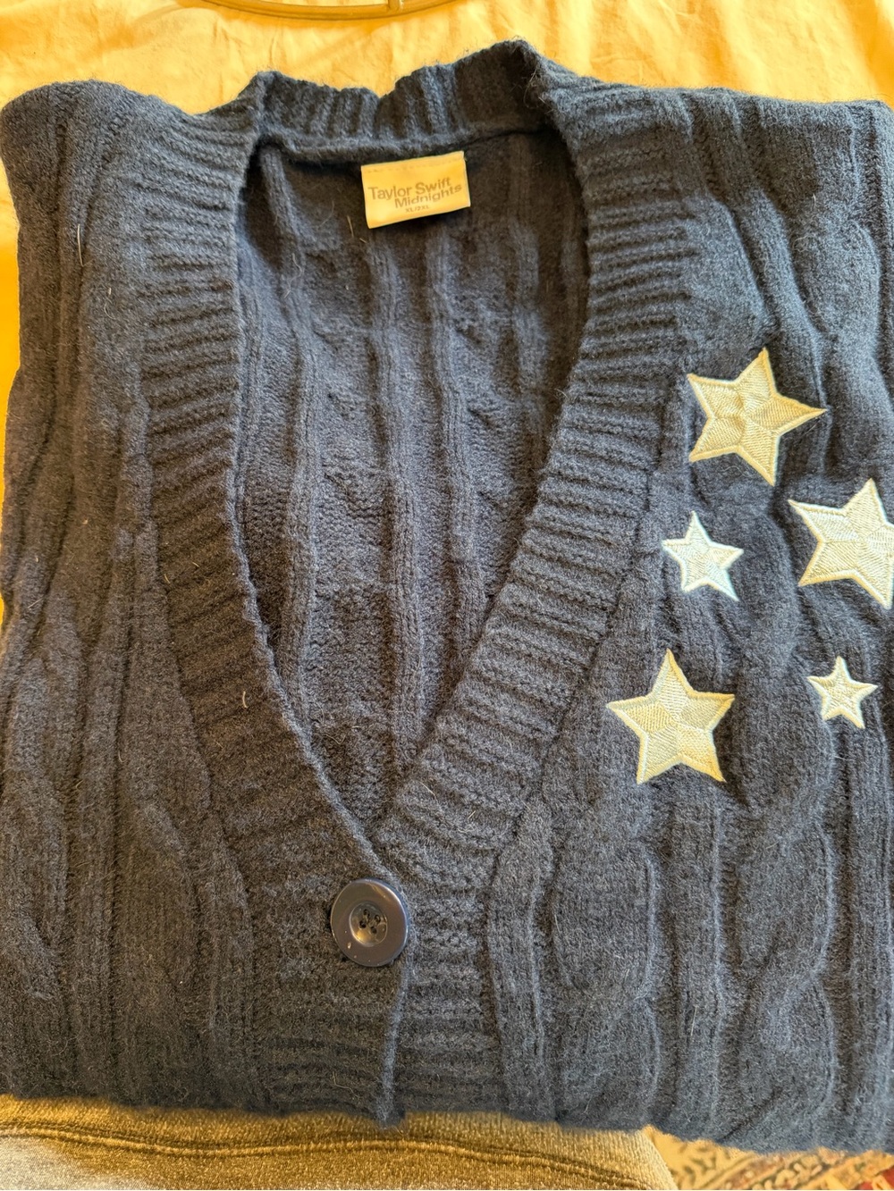 Taylor Swift navy blue cardigan with gold star appliqués